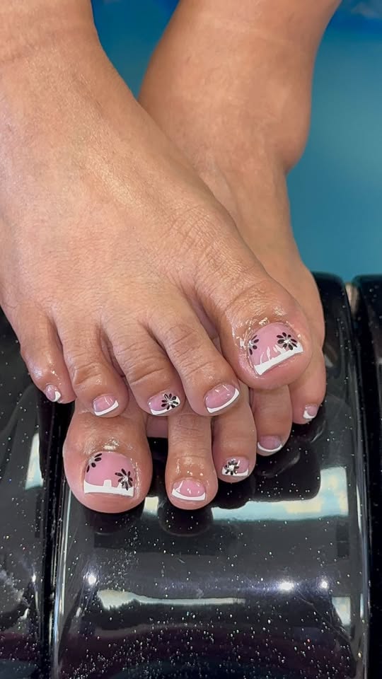 French pedicure with black daisy flower art