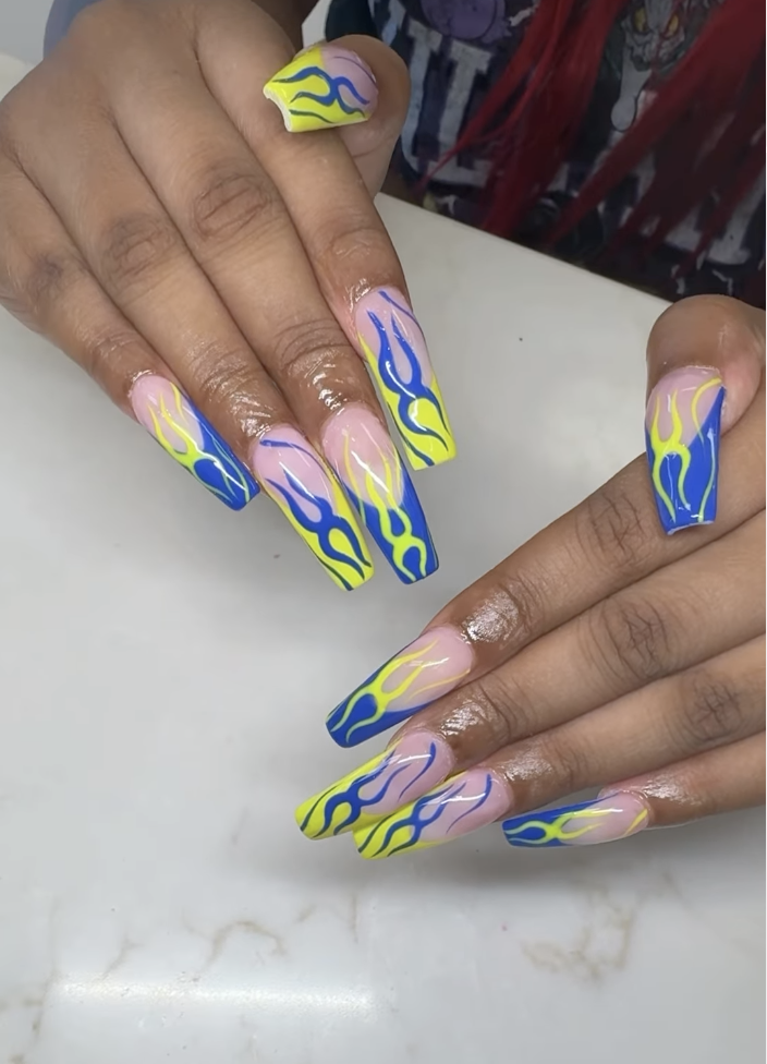 Long coffin nails with blue and yellow flame nail art