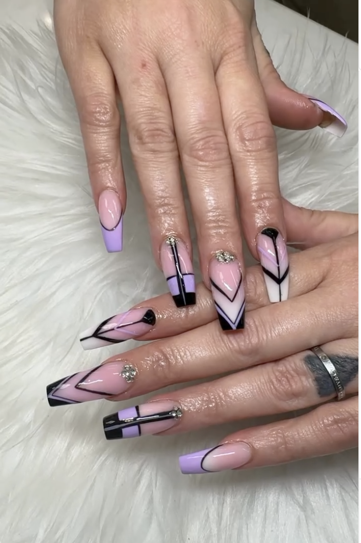 Lavender and black chevron coffin nails with rhinestone accents