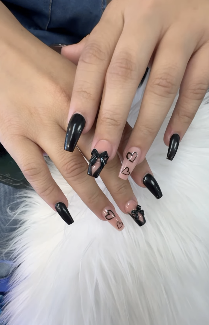 Glossy black coffin nails with 3D bows and heart outline accents