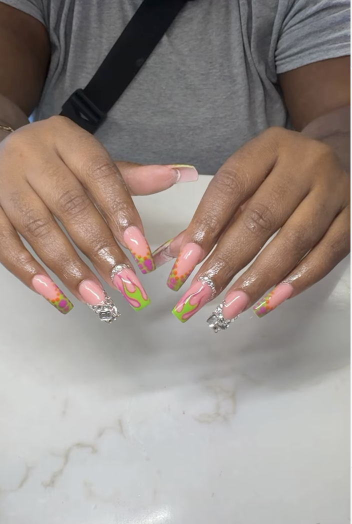 Neon green flame French tips on long coffin nails with rhinestones