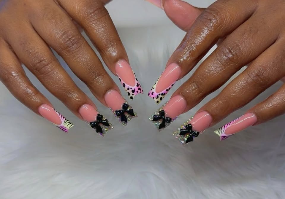 Pink coffin nails with black bows, leopard and zebra tips